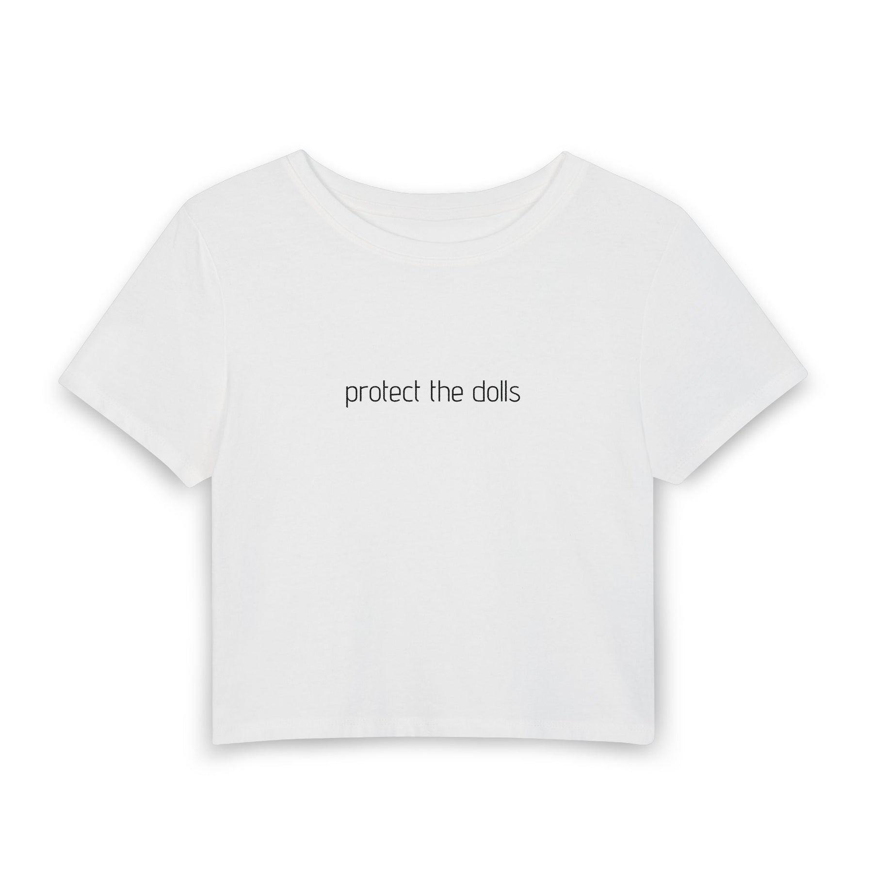 A white short-sleeve crop top t-shirt with the phrase 'protect the dolls' printed in a black lowercase serif font across the chest, displayed on a clean white background.