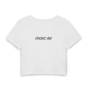 A white short-sleeve crop top t-shirt with the words 'CHOKE ME' printed in black script across the chest, displayed on a clean white background.