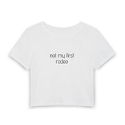 A white short-sleeve crop top t-shirt with a small gray graphic on the chest, displayed against a solid white background.